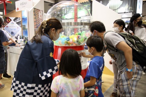 カプセルトイマシーンを引く家族